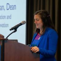 Emily Miller shares remarks at the podium